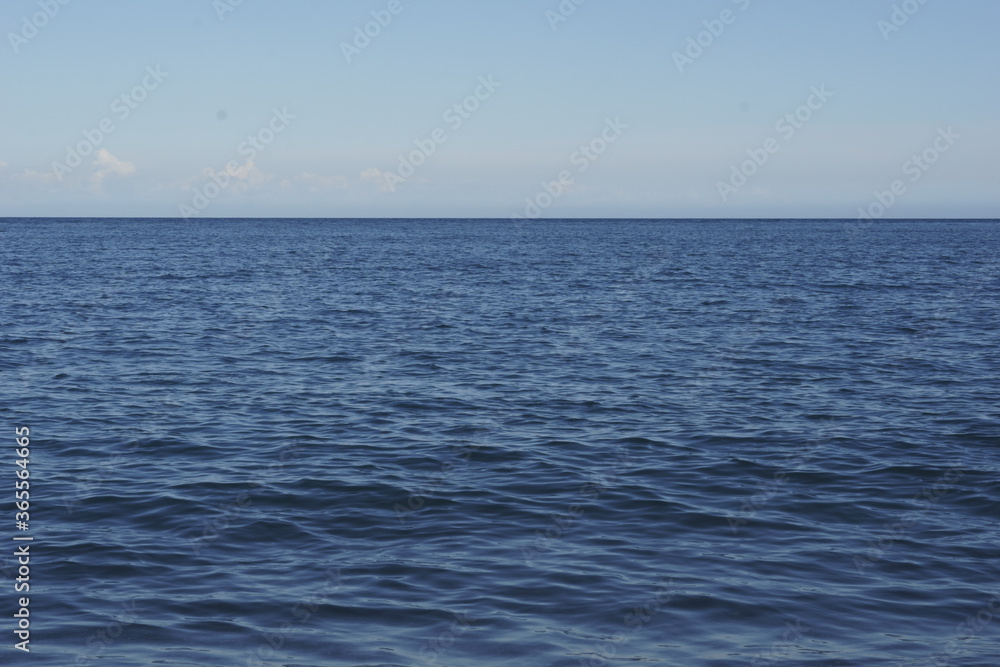 View of horizon with calm blue sea View of horizon with calm blue sea