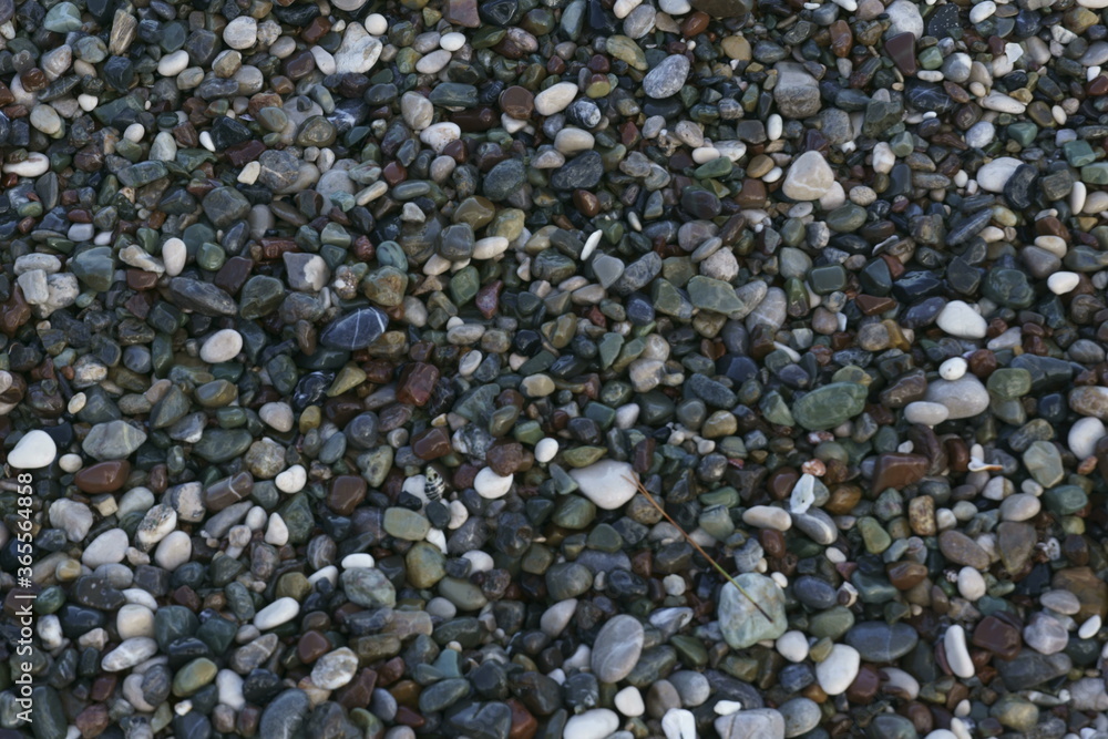 Closeup view of small stones on the beach with colorful pattern Closeup view of small stones on the beach with colorful pattern
