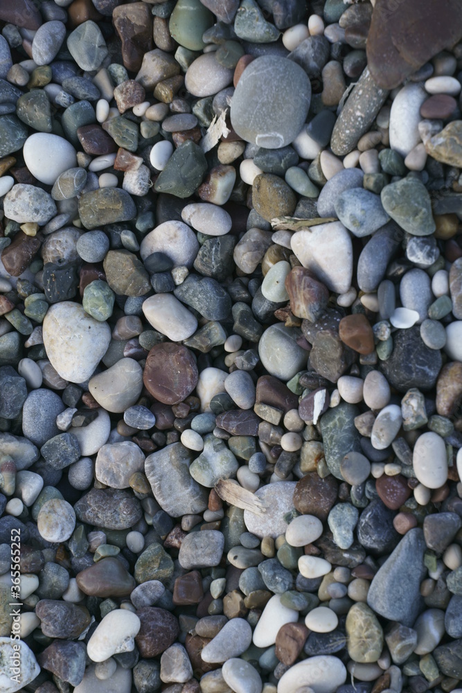 Closeup view of small stones on the beach with colorful pattern Closeup view of small stones on the beach with colorful pattern