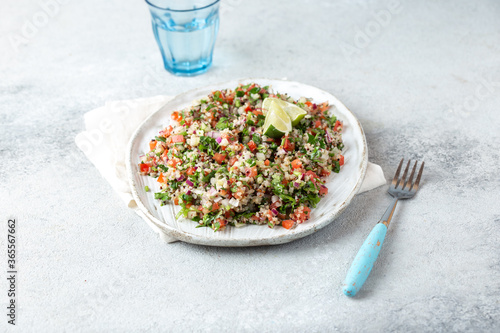 Bilde på lerret Quinoa Quinua salad with tomatoes and herbs in white bowl