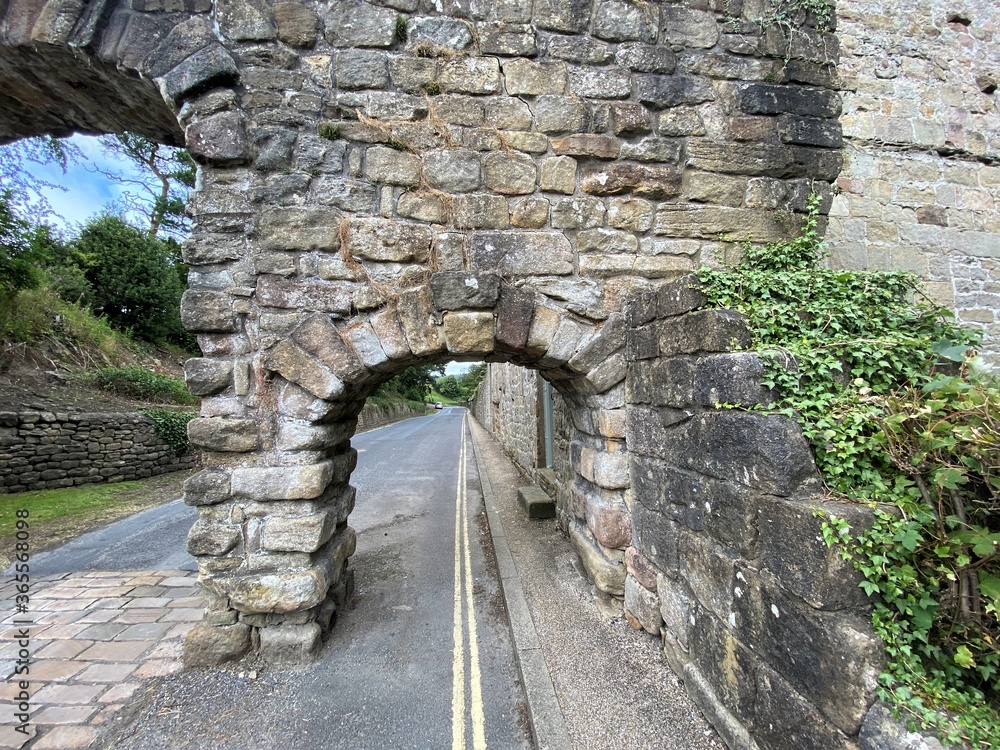 Small arch, part of the larger aqueduct, that spans the road at Bolton Abbey, Skipton, UK