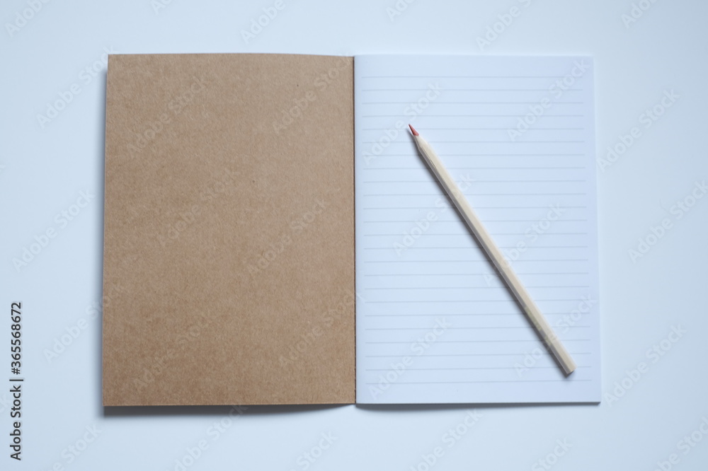 top view open notebook, pencil on white desk background top view open notebook, pencil on white desk background