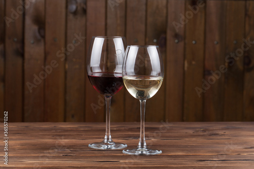 white and red wine on a wooden background