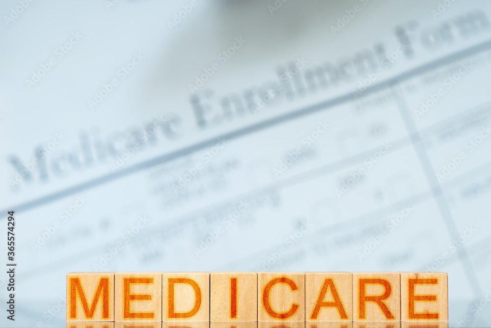 medicare concept. wooden blocks with the inscription on the background with Medicare enrollment form medicare concept. wooden blocks with the inscription on the background with Medicare enrollment form