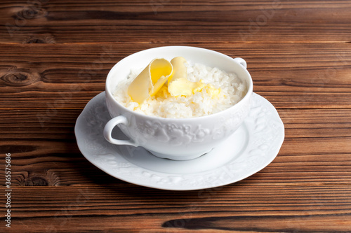 rice porridge with butter on a wooden background