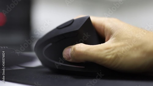 hand uses a vertical ergonomic computer mouse joystick. photo