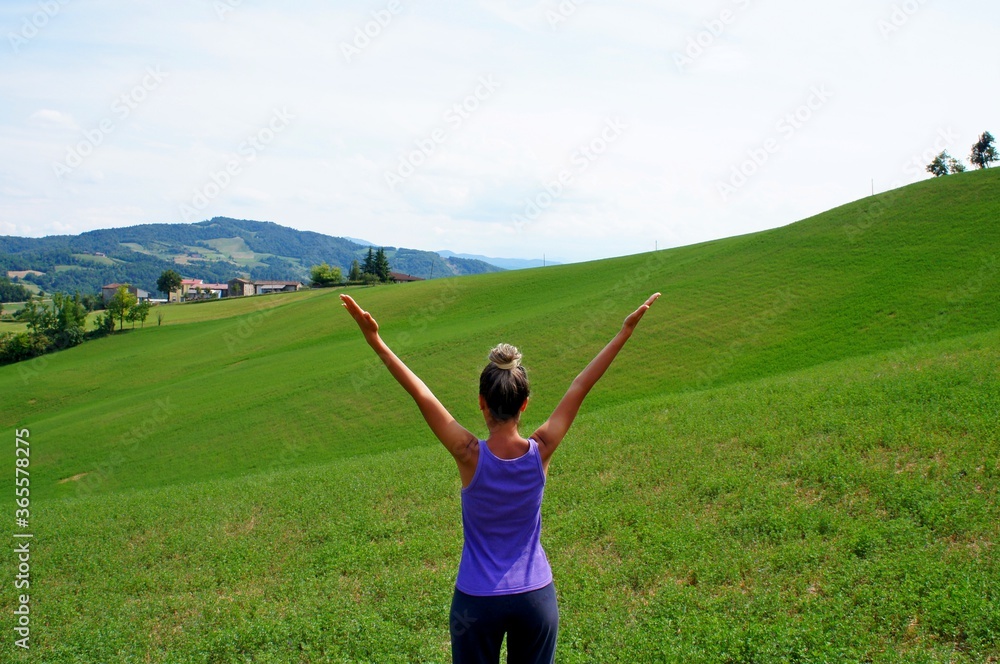 Young girl doing yoga on the green meadow Young girl doing yoga on the green meadow