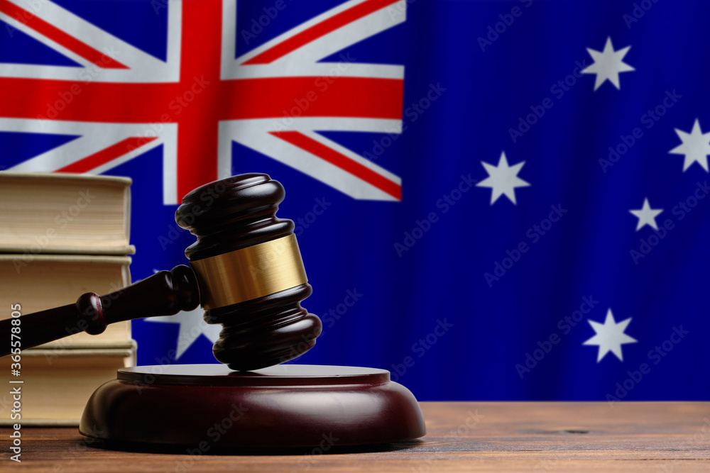 Justice and court concept in Commonwealth of Australia. Judge hammer on a flag background