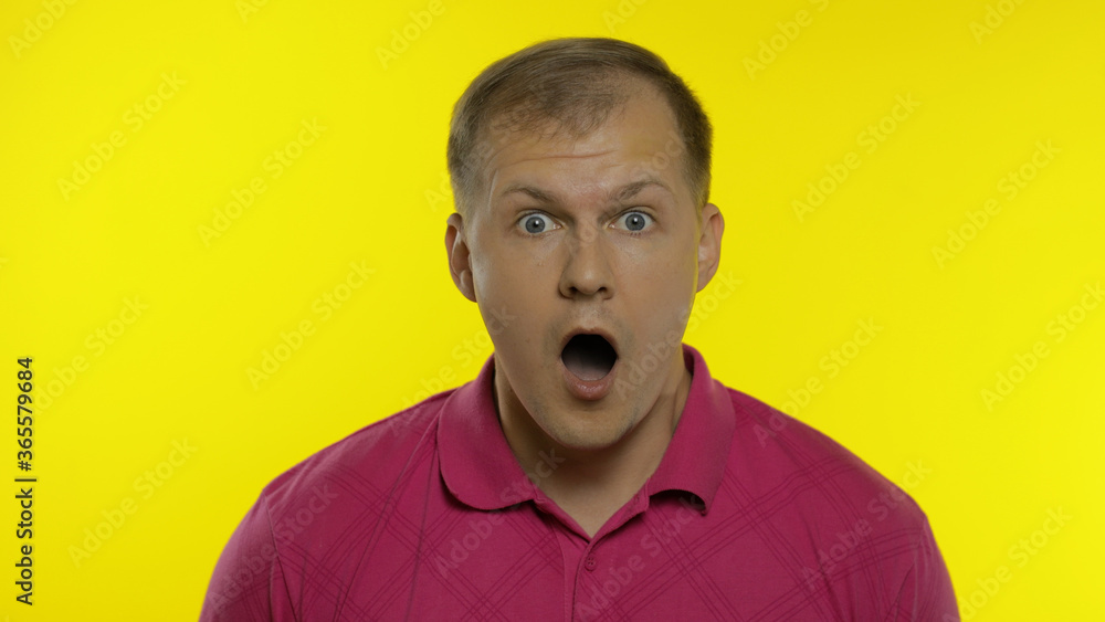 Portrait of young caucasian man posing in pink t-shirt. Amazed handsome guy shocked, surprised Portrait of young caucasian man posing in pink t-shirt. Amazed handsome guy shocked, surprised