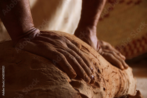 A man doing hand-made pottery clay handicrafts photo