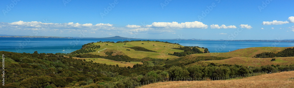 Scenic view (panorama) of Shakespear Regional Park and the Hauraki Gulf, with Rangitoto Island and Auckland City in the background, from Whangaparaoa Peninsula, Auckland, New Zealand