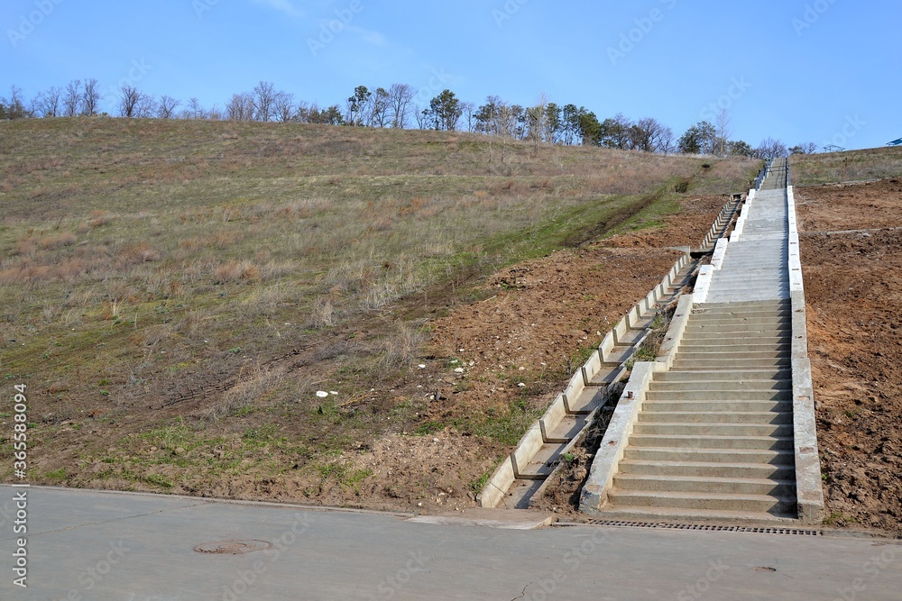 Partially restored staircase on a crumbling slope Partially restored staircase on a crumbling slope