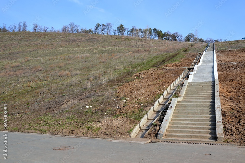 Partially restored staircase on a crumbling slope