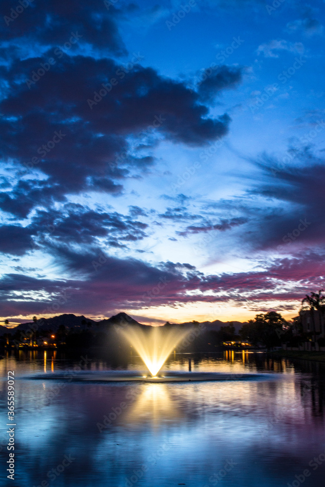 Sunset over the lake and the fountain