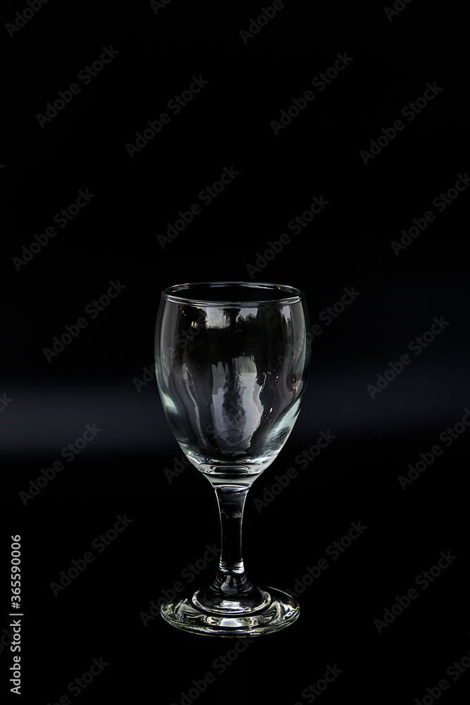 A beautiful wine glass in a glass on a black background With copy space A beautiful wine glass in a glass on a black background With copy space