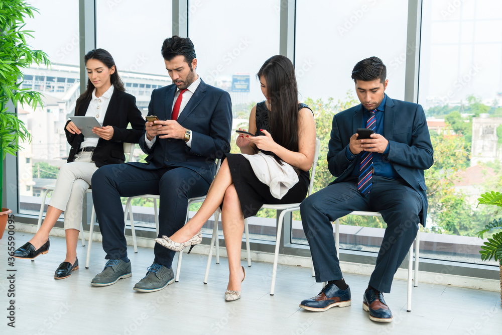 Job seekers and applicants waiting for interview on chairs in office