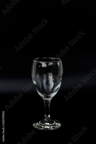 A beautiful wine glass in a glass on a black background With copy space