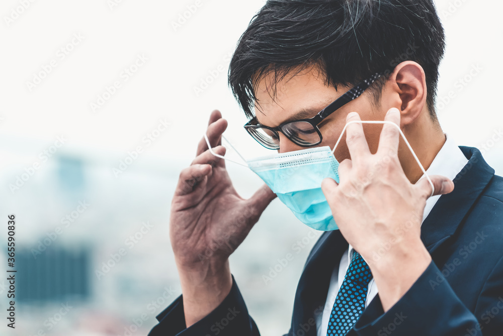 Plakat Young office worker with face mask quarantine from coronavirus or COVID-19. Concept of protective working environment to reopen business and stop spreading of coronavirus or COVID-19.