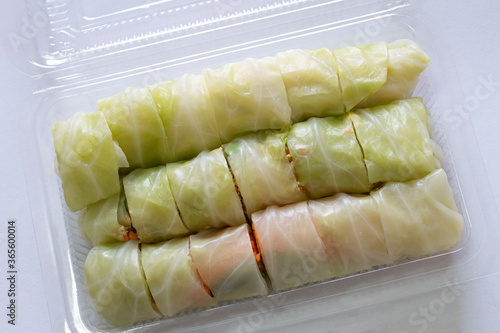 salad roll. mixed minced pork, Vietnam sausageand vegetable roll in steamed cabbage arranged in plastic take away box on white background