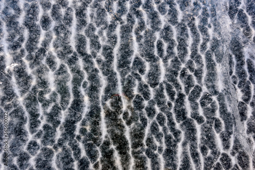 Beautiful abstract frozen gray ripples of water of Lake Baikal