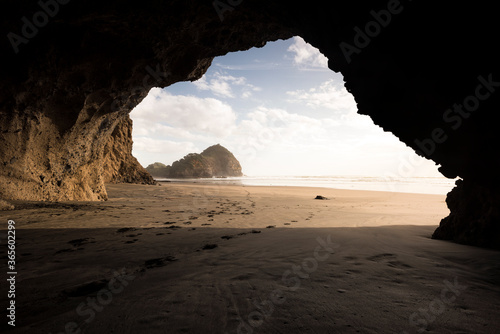 cave on bethells beach, new zealand