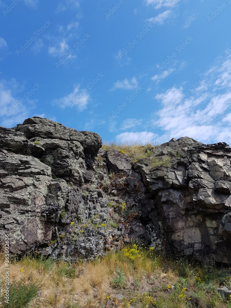 Stone rocks on a background of blue sky