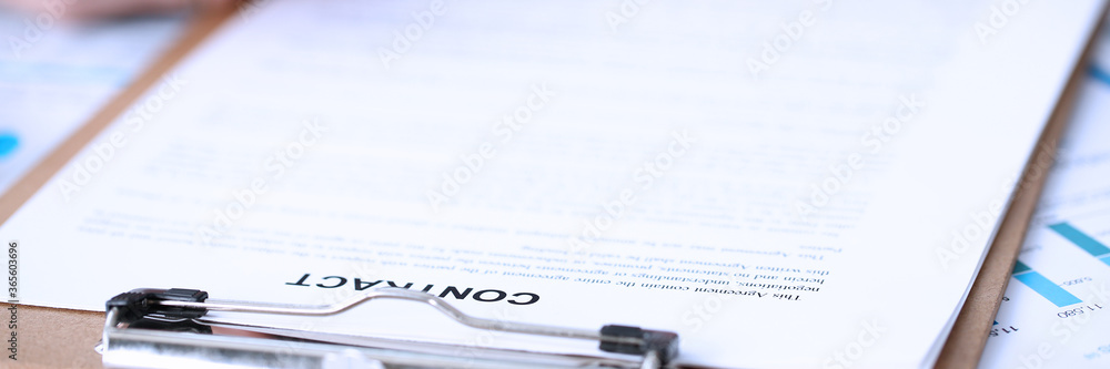 Obraz premium Male arm in suit and tie fill form clipped pad with silver pen closeup. Sign gesture read pact sale agent bank job make note loan credit mortgage investment finance executive chief legal teamwork law