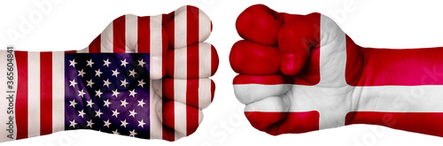 Fototapeta Naklejka Na Ścianę i Meble -  Two hands are clenched into fists and are located opposite each other. Hands painted in the colors of the flags of the countries. Denmark vs USA
