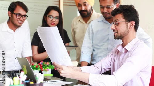 Indian office team brainstorming over the document