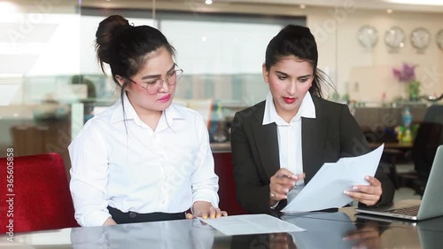 Two indian colleagues doing paperwork