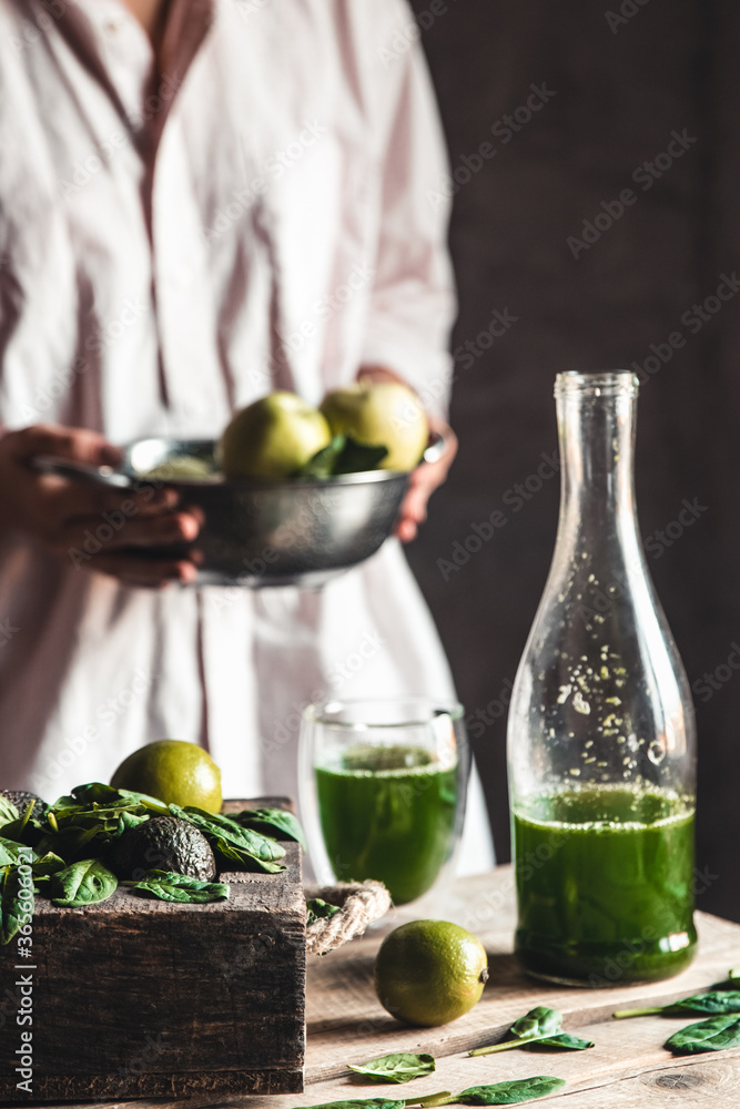 Woman tugs at the market with apples, smoothie in a glass, detox, wholesome food, vegan, eco. Woman tugs at the market with apples, smoothie in a glass, detox, wholesome food, vegan, eco.
