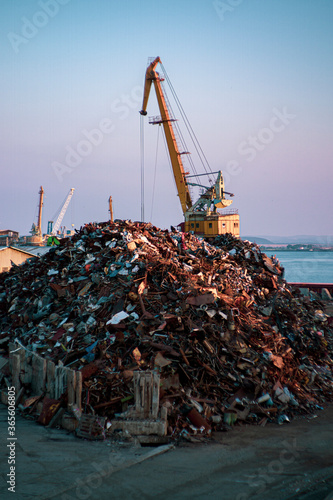 Garbage pile in trash dump or junkyard, metal crane garbage consumption junkyard scarp, Global warming, Ecosystem and environment concepts and background.