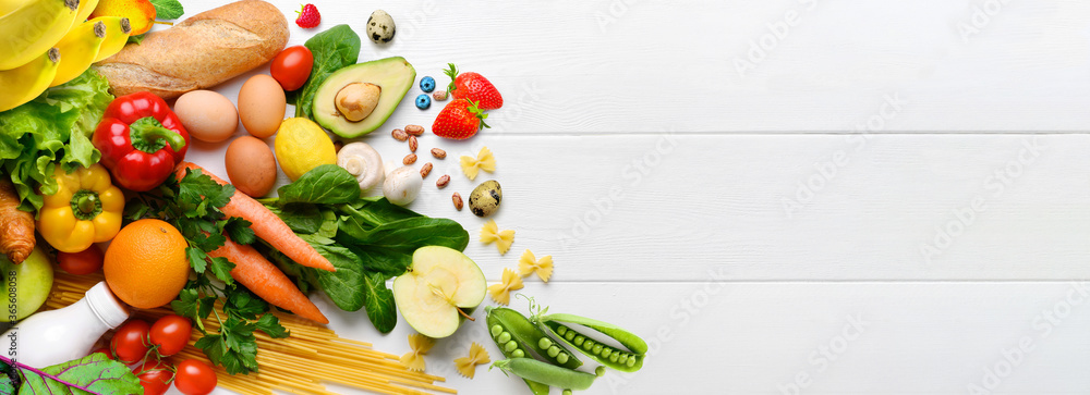 Organic healthy food background. Different fruits and vegetables on white wooden table background. Copy space. Top view