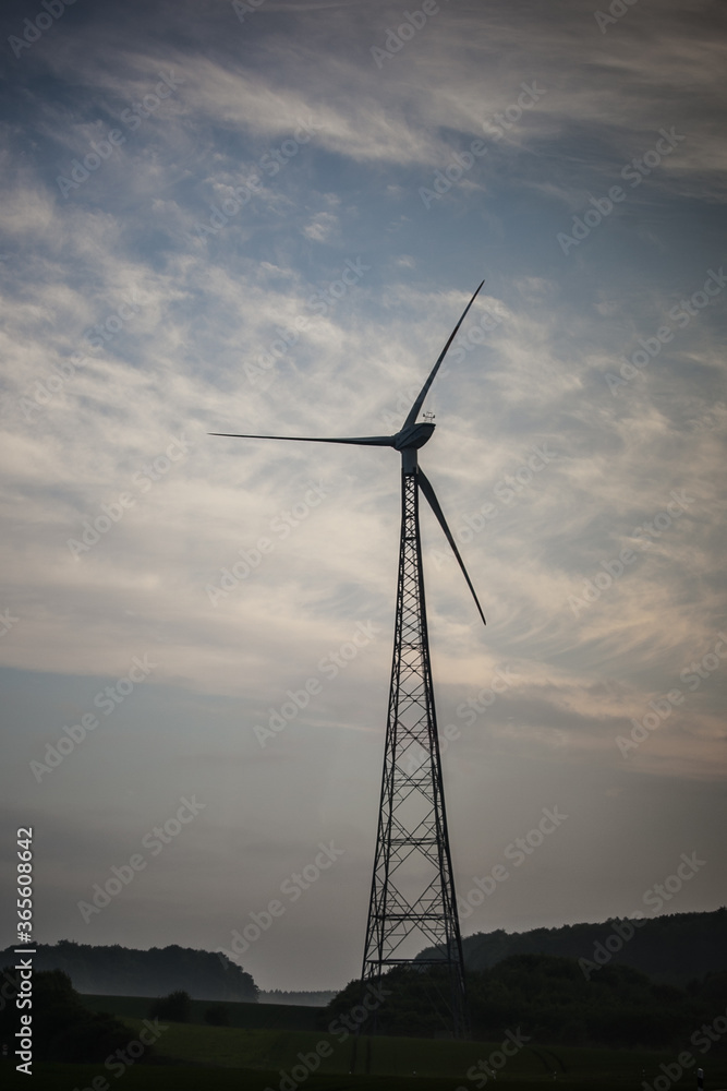 windmill in a field in cloudy weather windmill in a field in cloudy weather