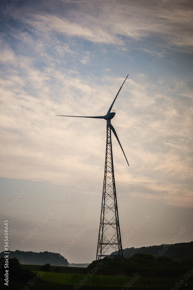 windmill in a field in cloudy weather windmill in a field in cloudy weather