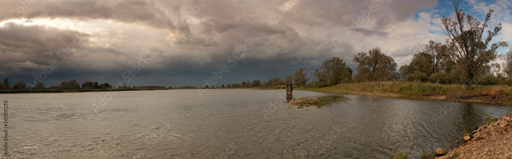 Storm clouds flowing over the river Storm clouds flowing over the river