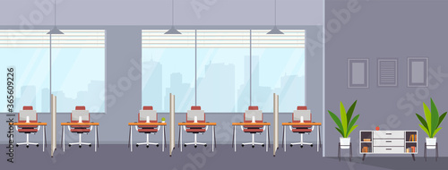 Empty modern office interior open co-working creative space with separate workplaces and hallway. Shared work environment with desktop, modern monitors, interior furnishings.