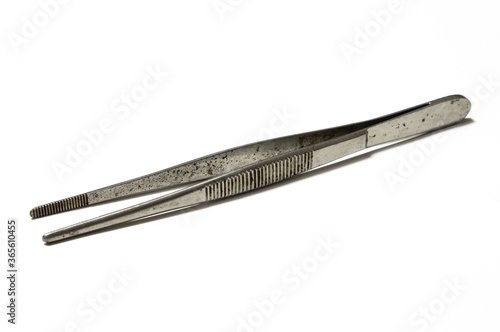 Rusty and old forceps on white background.