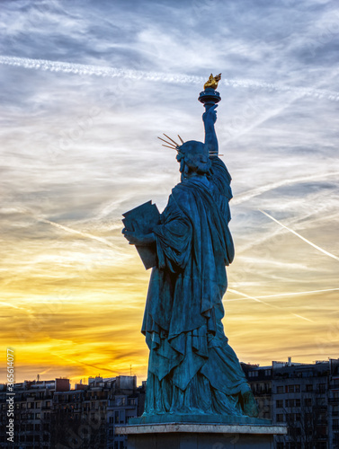 Famous Statue de la Liberte against the sunset during a bright day of February with dramatic sky - Paris  France. This statue was given in 1889 to France by U.S. citizens living in Paris.