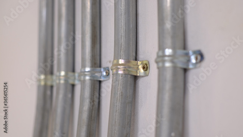 Mild Steel Saddle Spacer Conduit Clamp, for Electrical Fitting . Focus is second conduit clamp right hand