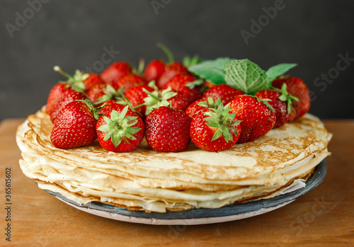 Pancakes with berries. Breakfast. Sweet homemade stack of pancakes