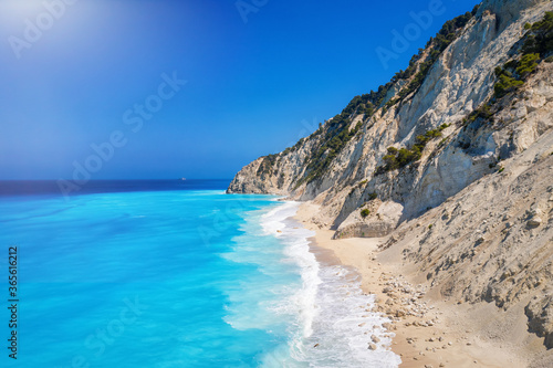 The remote Egremni beach on Lefkada island, Greece, with its beautiful, turquoise sea and waves hitting the white rocks