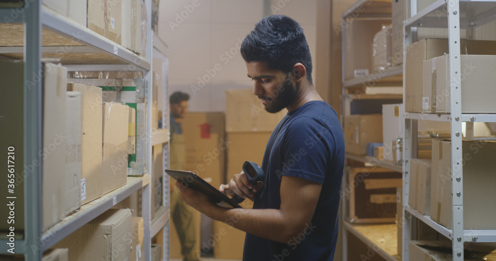 Workers checking boxes in a distribution center