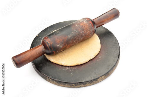 the brown wooden  chakla  bellan with unleavened bread. photo