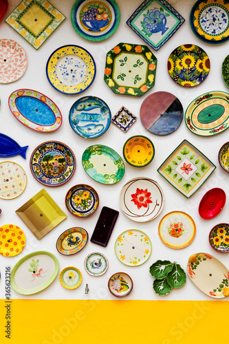 ALGARVE, PORTUGAL - APRIL 28, 2017: Vintage clay plates, pots and bowls used as a wall decoration motif. Portugal