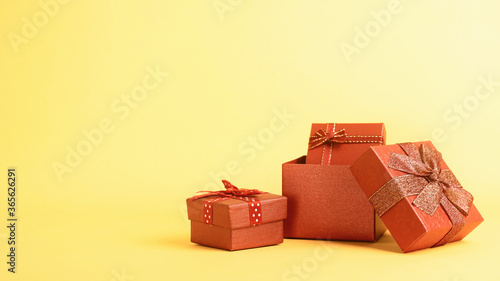 Group of red gift boxes on yellow background,have space for idea.