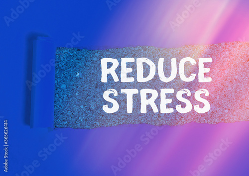 Word writing text Reduce Stress. Business photo showcasing to lessen the state of mental or emotional strain or tension Rolled ripped torn cardboard placed above a wooden classic table backdrop photo