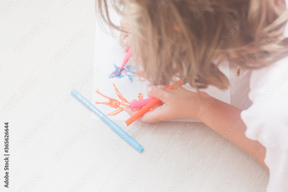 Favorite activity of the child. A happy family. The girl draws with colored markers. Girl's hands. Favorite activity of the child. A happy family. The girl draws with colored markers. Girl's hands.