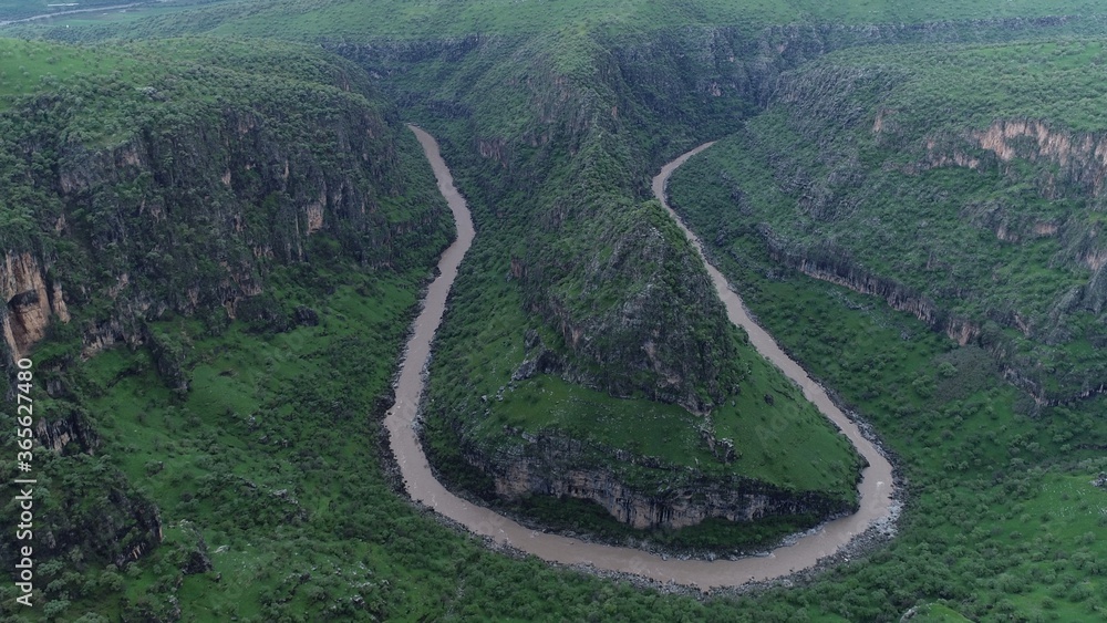 Aerial view of river in the mountain. Green hills. Aerial view of river in the mountain. Green hills.