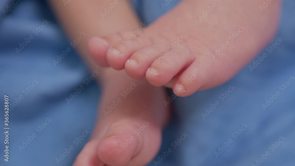 Little feet of a newborn baby. Caring for a child. Closeup. Little feet of a newborn baby. Caring for a child. Closeup.